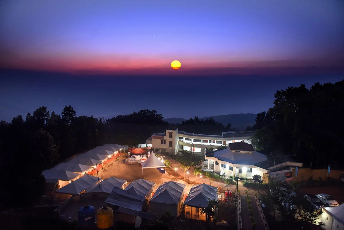 Prabhat Vihar at Netarhat beneath a colourful evening sky